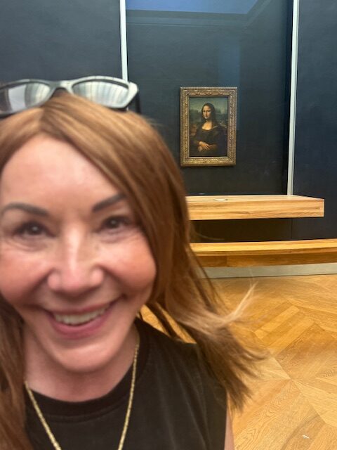 Debra at the Louvre with the Mona Lisa in the background