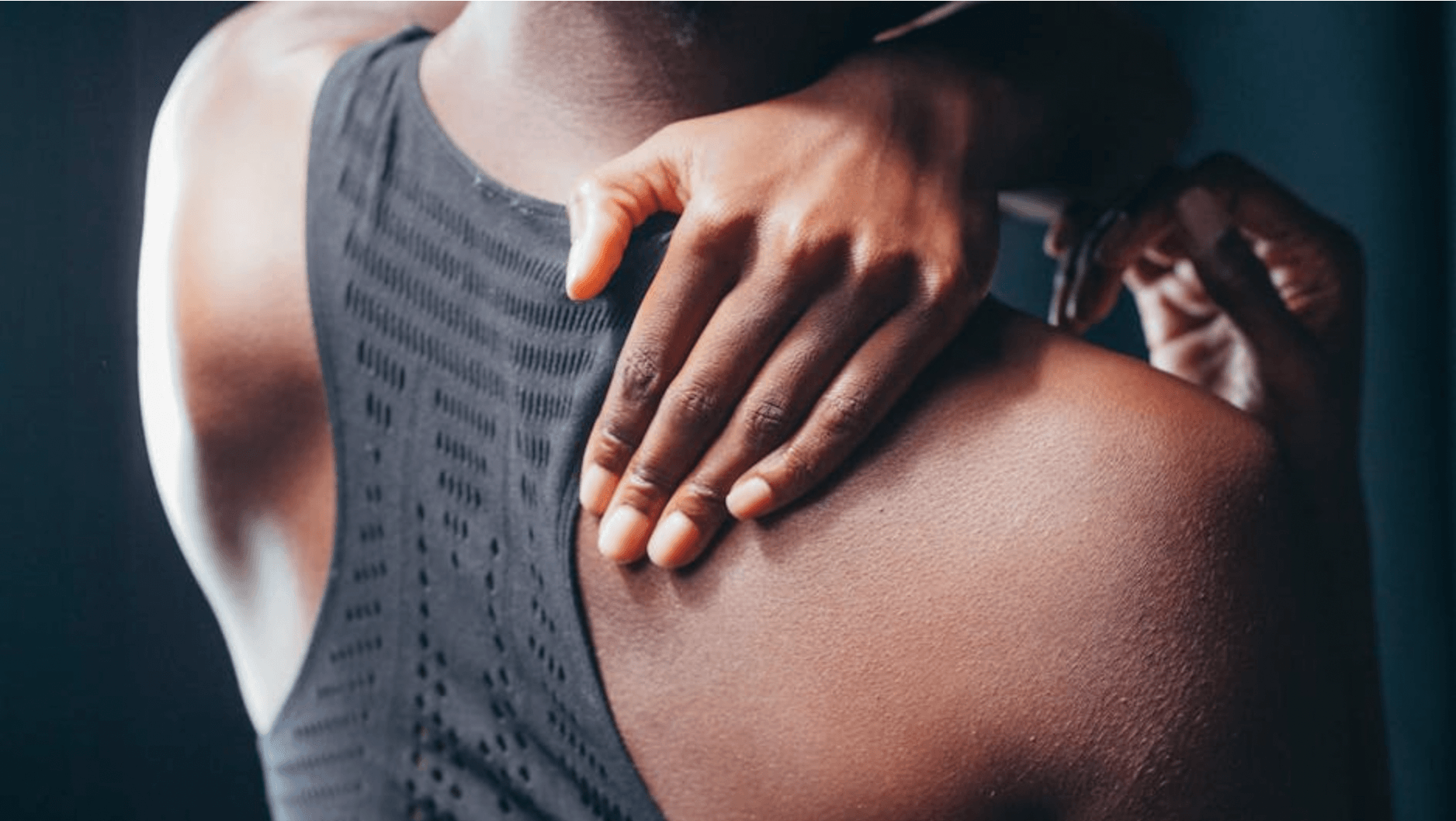 Woman rubbing her shoulder/back pain