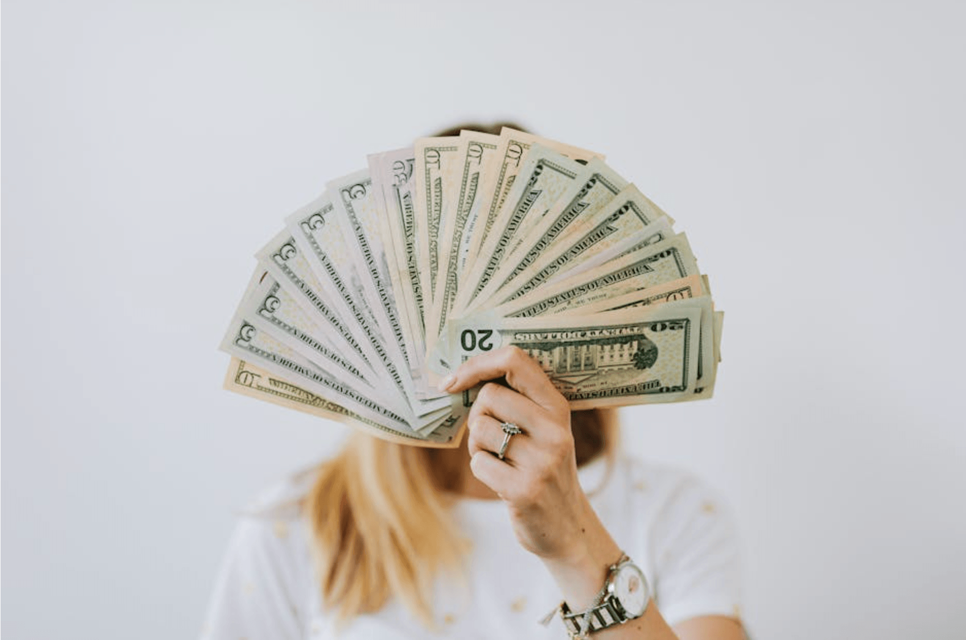Woman holding a bunch of money